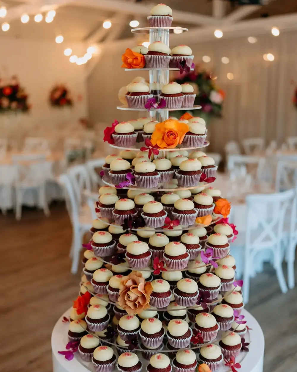 A tall Miss Sprinkles cupcake tower at a reception